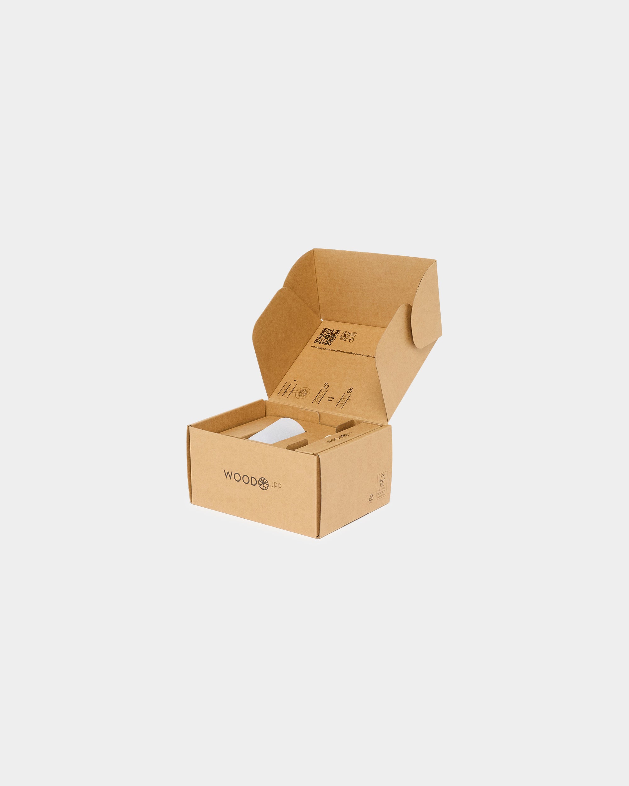 Open brown cardboard box with WoodUpp logo and internal cardboard inserts on a plain white background